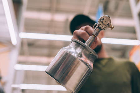 A man chooses a spray gun at a hardware storeの写真素材