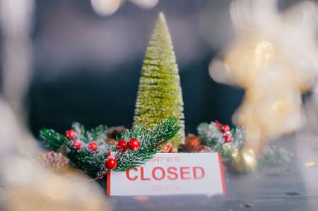 Sorry, we are closed. Festive composition for new year and christmas. Christmas tree with decoration on a wooden tableの写真素材