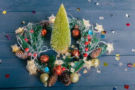Festive composition for new year and christmas. Christmas tree with decoration on a wooden tableの写真素材