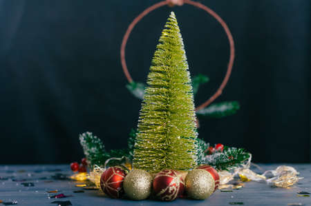 Festive composition for new year and christmas. Christmas tree with decoration on a wooden tableの写真素材