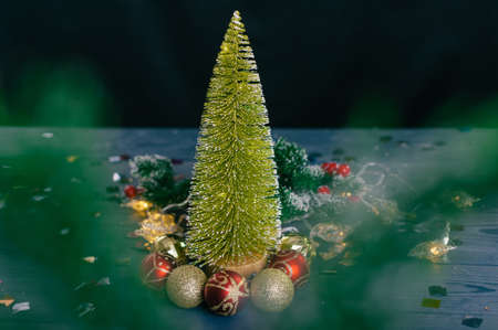 Festive composition for new year and christmas. Christmas tree with decoration on a wooden tableの写真素材