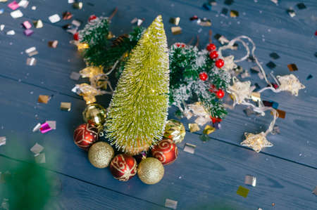 Festive composition for new year and christmas. Christmas tree with decoration on a wooden tableの写真素材