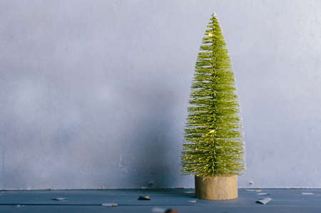 Festive composition for new year and christmas. Christmas tree with decoration on a wooden tableの写真素材