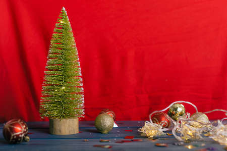 Festive composition for new year and christmas. Christmas tree with decoration on a wooden tableの写真素材