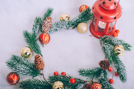 Festive composition for new year and christmas. Christmas tree with decoration and lamp on a white tableの写真素材