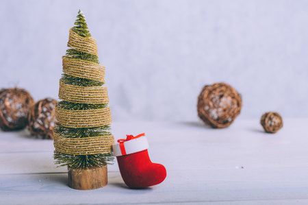 Festive composition for new year and christmas. Christmas tree with decoration on a wooden tableの写真素材