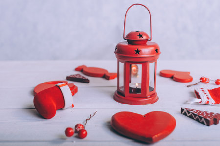 Red lamp with festive decoration for the new year on a wooden backgroundの写真素材
