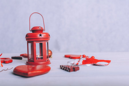 Red lamp with festive decoration for the new year on a wooden backgroundの写真素材