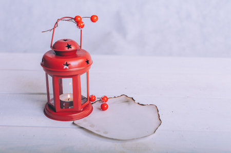 Festive lamp with burnt paper mockup on wooden backgroundの写真素材