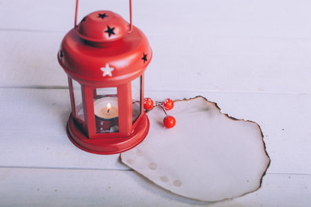 Festive lamp with burnt paper mockup on wooden backgroundの写真素材