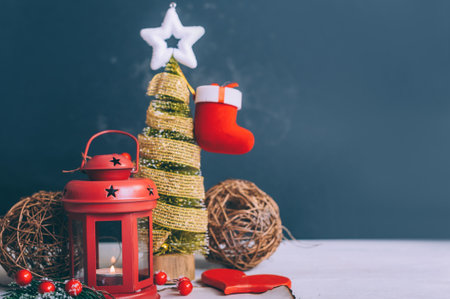 Festive composition for new year and christmas. Christmas tree with decoration and lamp on a white tableの写真素材