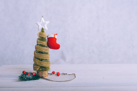 Festive composition for new year and christmas. Christmas tree with decoration on a wooden tableの写真素材