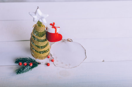 Festive composition for new year and christmas. Christmas tree with decoration on a wooden tableの写真素材