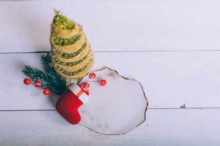 Festive composition for new year and christmas. Christmas tree with decoration on a wooden tableの写真素材