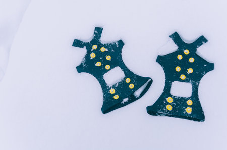 Ice shoes for shoes on a background of snowの写真素材
