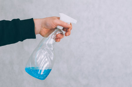 Man with a blue antiseptic in his hand. Protection and preventionの写真素材