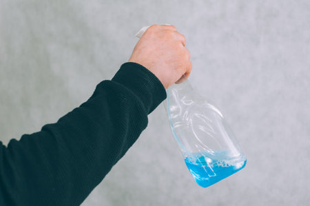 Man with a blue antiseptic in his hand. Protection and prevention from COVID-19の写真素材