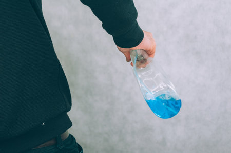 Man with a blue antiseptic in his hand. Protection and prevention from COVID-19の写真素材
