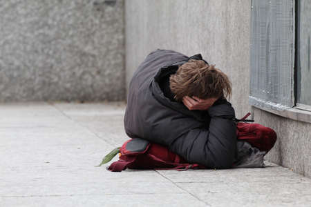Homeless man lying on the ground in Edinburgh Scotlandの写真素材