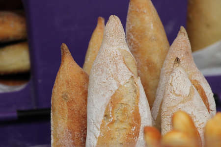 Close up of fresh French baguette bread at a food market stallの写真素材