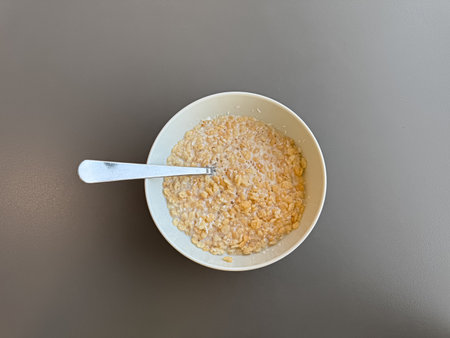 Above view of a bowl of rice based breakfast cereals with desiccated coconut in dairy milkの写真素材