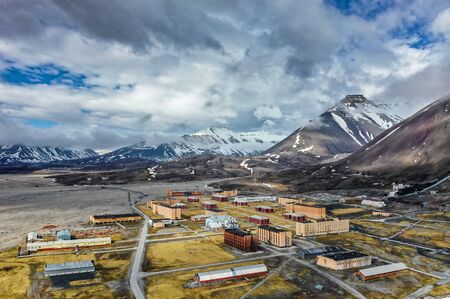 Aerial view of scenic town on island with mountain peaks during sunny summer dayの写真素材