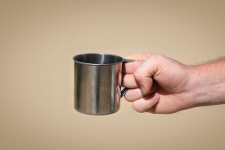 Iron mug in hand please pour waterの写真素材
