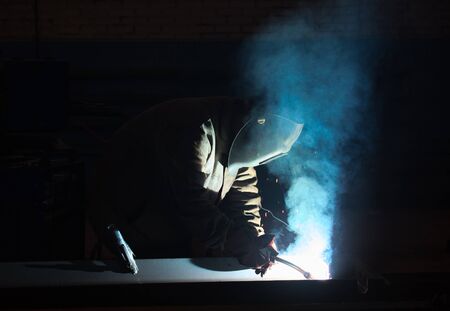 Welder at work performs welding of metal structuresの写真素材