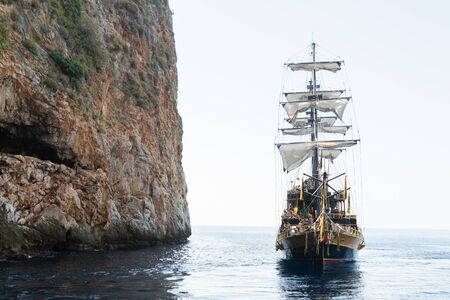 Pirate ship on the sea with people