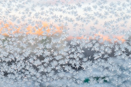 Frozen snowflakes on the window, winter backgroundの写真素材