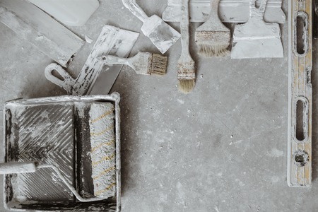 Plastering tools on cement background. View from top.の写真素材