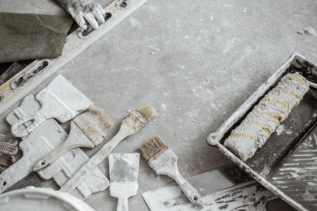 Plastering tools on cement background. View from top.の写真素材