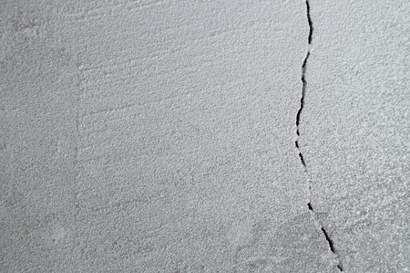 Crack in cement floor from shrinkage of house. The problem of construction. Background.の写真素材
