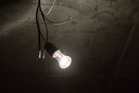 Light bulb illuminates a dark room. Construction background.の写真素材