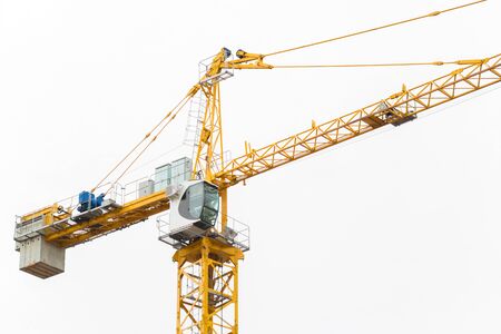 Tower crane closeup on the background of white skyの写真素材