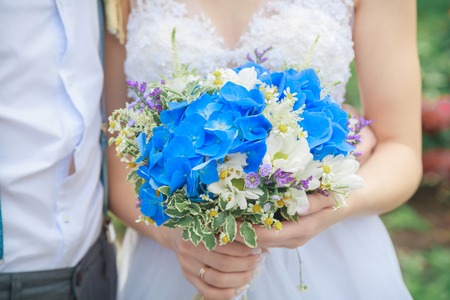 Bride holding a wedding bouquet of natural flowersの写真素材