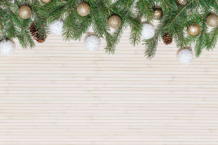 Christmas wooden background decorated fir branches and toysの写真素材