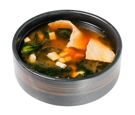 Sake suimono. Soup with salmon, tofu and seaweed. Isolated on white background. Asian cuisine.の写真素材