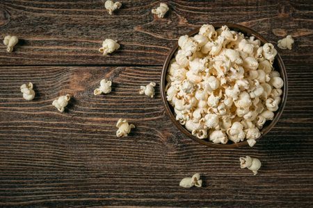 Popcorn in bowl on old wooden background. Copy space.の写真素材