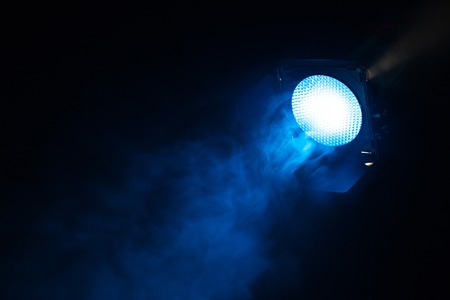 Blue light with smoke on dark background. Equipment for photo Studio.