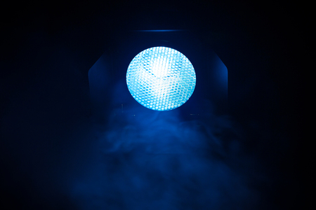 Blue light with smoke on dark background. Equipment for photo Studio.の写真素材