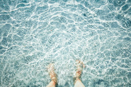 Feet in the water. Vacation and travel concept. vintage tone