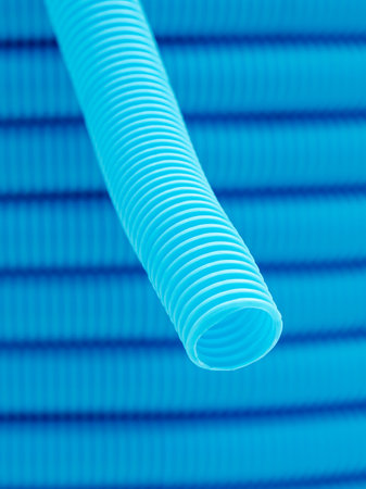 Plastic corrugated hose closeup. Blue background.の写真素材