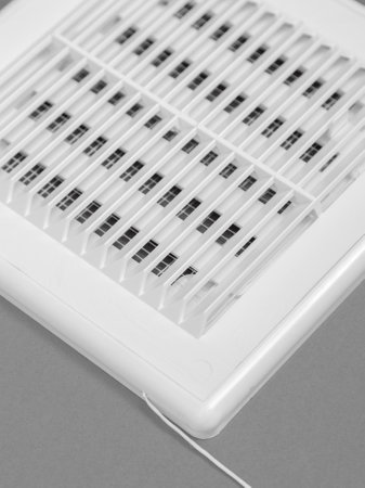 White ventilation grate on a gray background. Close-up. Material is plastic.の写真素材