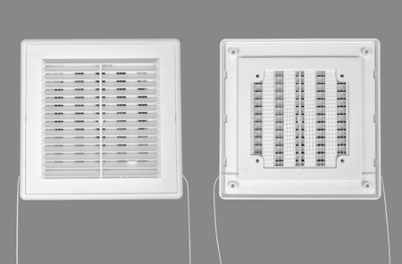 White ventilation grate on a gray background. Square shape, plastic material. Front and back sides.の写真素材