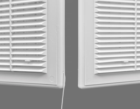 White ventilation grate on a gray background. Close-up. Material is plastic.の写真素材