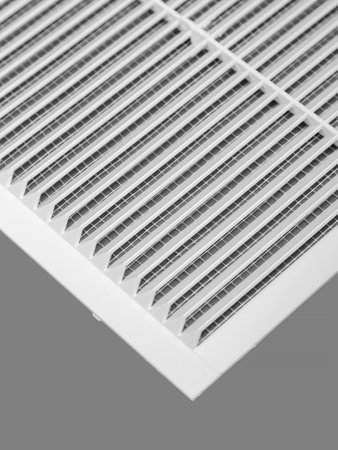 White ventilation grate on a gray background. Close-up. Material is plastic.の写真素材