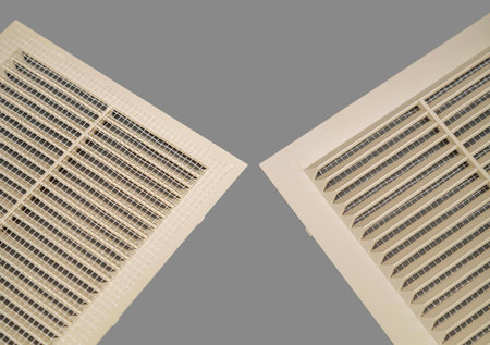 Beige ventilation grate on a gray background. Square shape, plastic material. Front and back sides.の写真素材