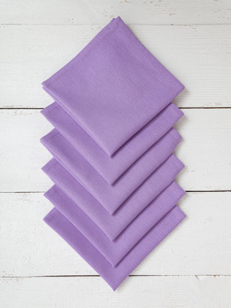 Purple napkins on a wooden white background.の写真素材