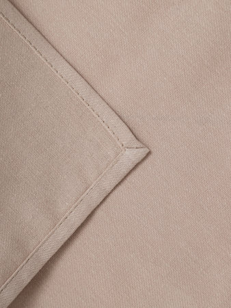 Beige napkin close-up. High-quality fabric and tailoring.の写真素材